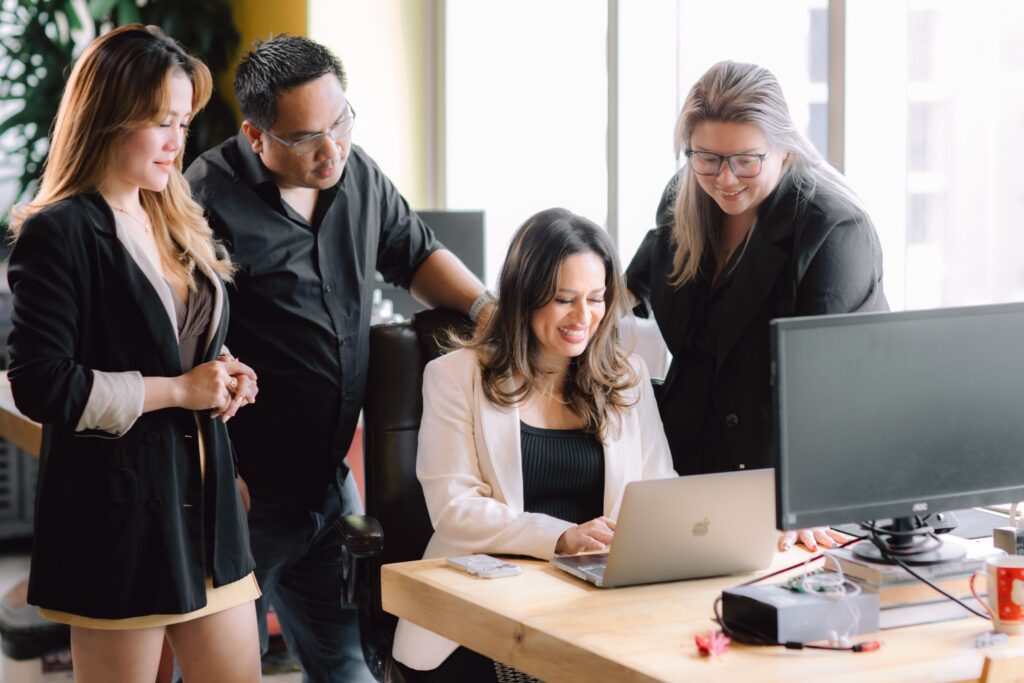 advice2talent team watching ceo working on laptop on desk