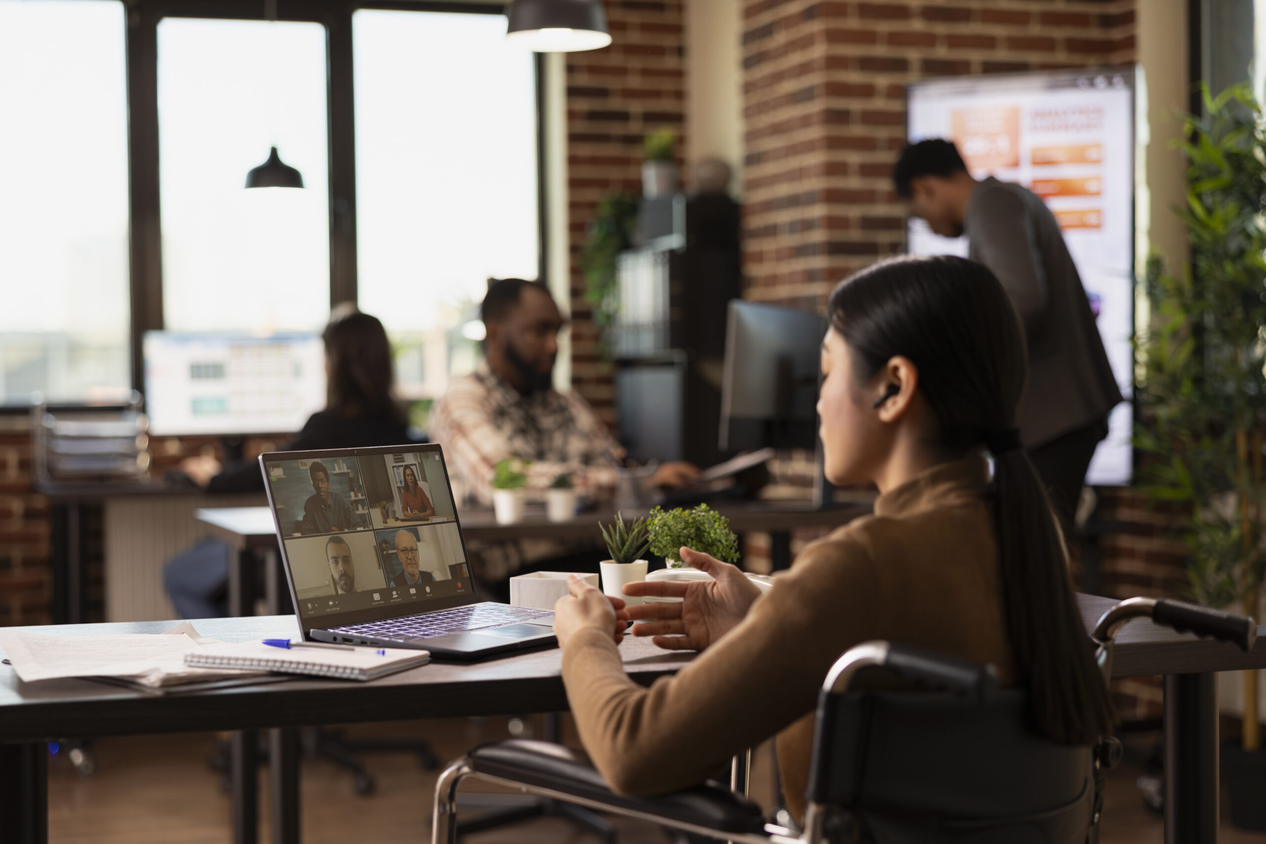 Businesswoman in a video call in the office with remote workers