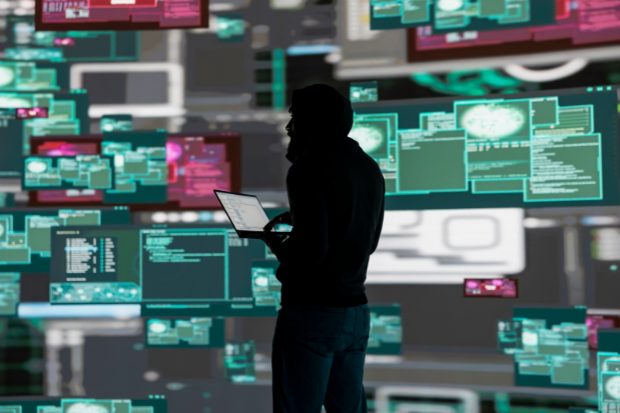 Cyber criminal exploiting a system vulnerability.