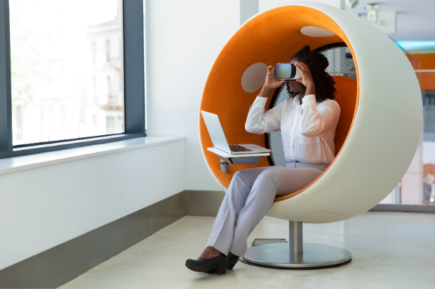Female office employee with laptop watching virtual presentation.
